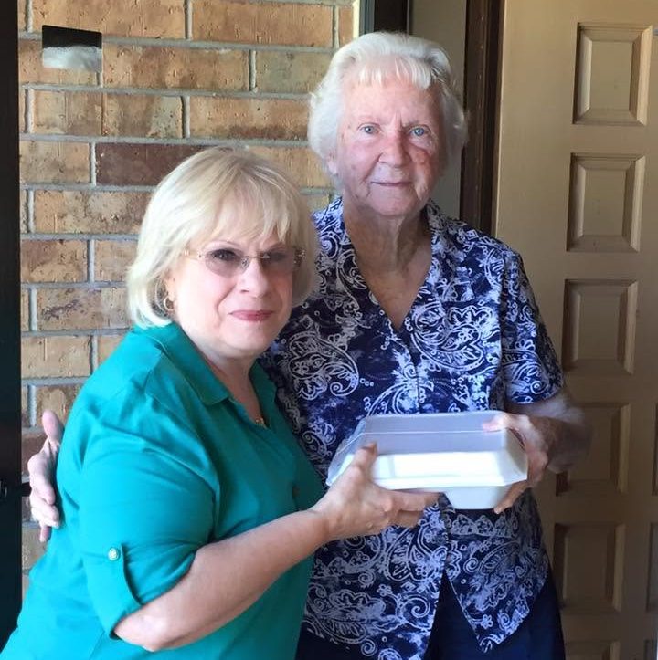 A volunteer and a Yukon mobile meals recipient