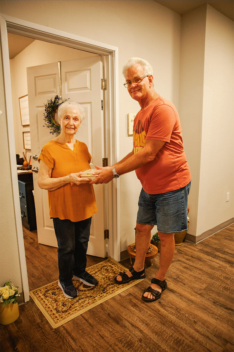 Volunteer delivering food to a happy recipient